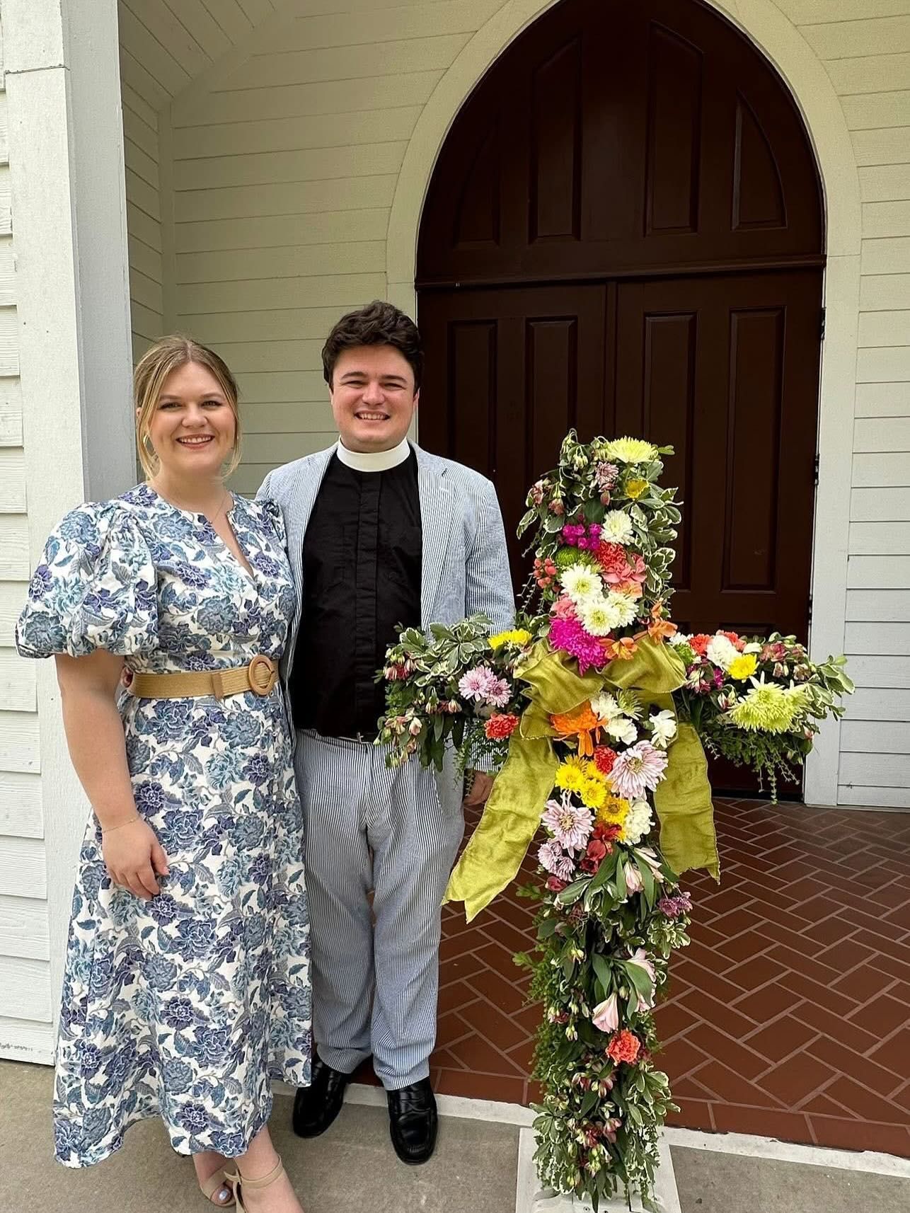 Fr. William and wife Alyson stand in front of the Sanctuary door at St. James Episcopal Church