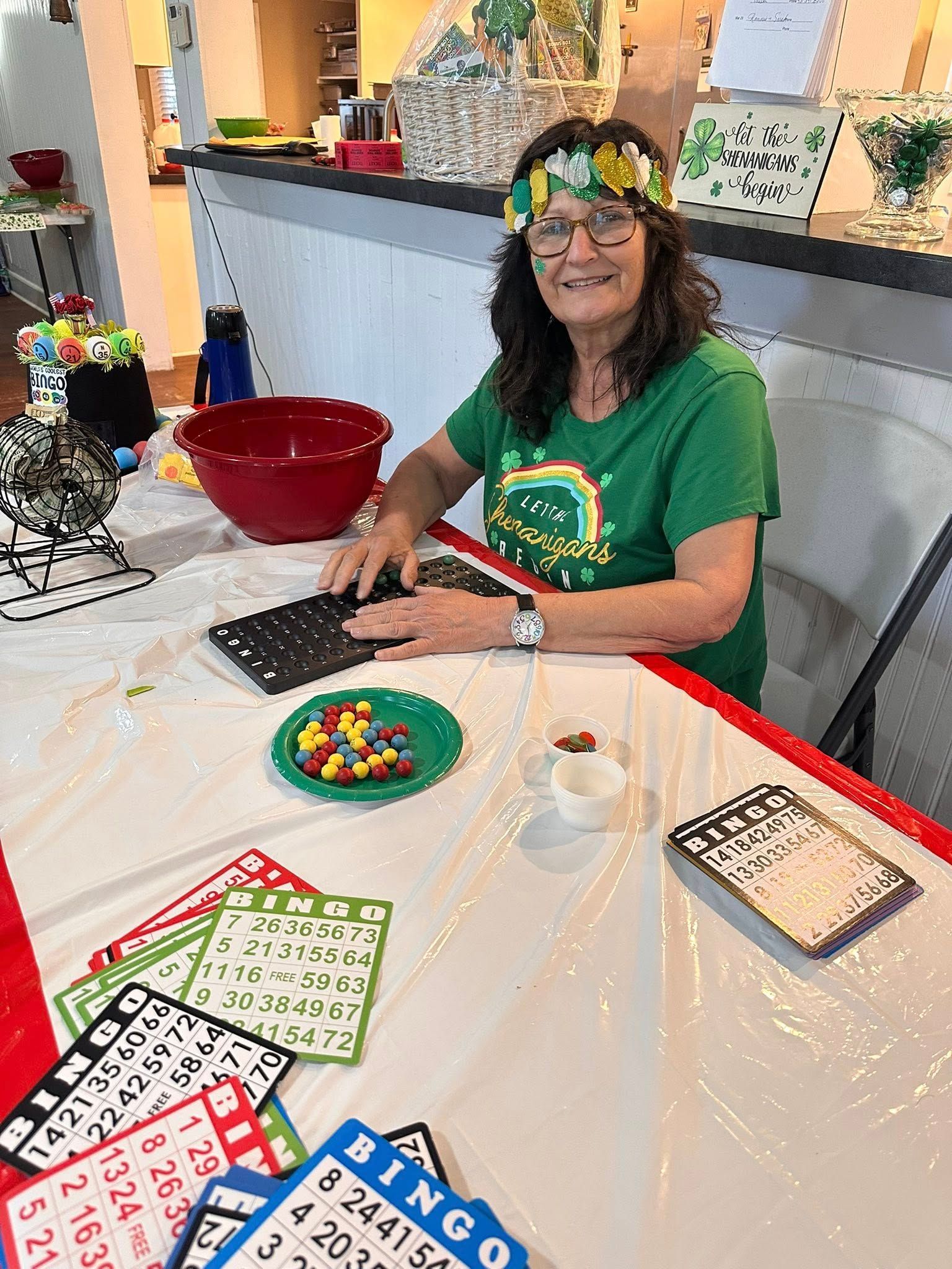 A church leader wearing festive clothing for St. Patrick's Day smiles during bingo in the Parish Hall