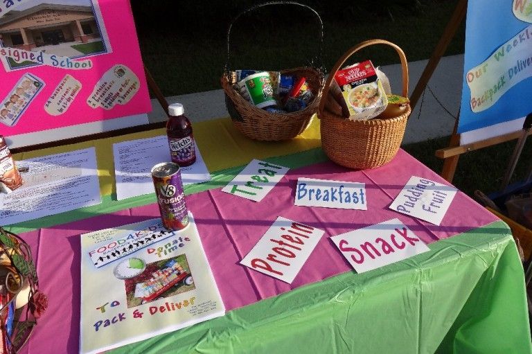 A table with a purple and green tablecloth and several cards with various words on them