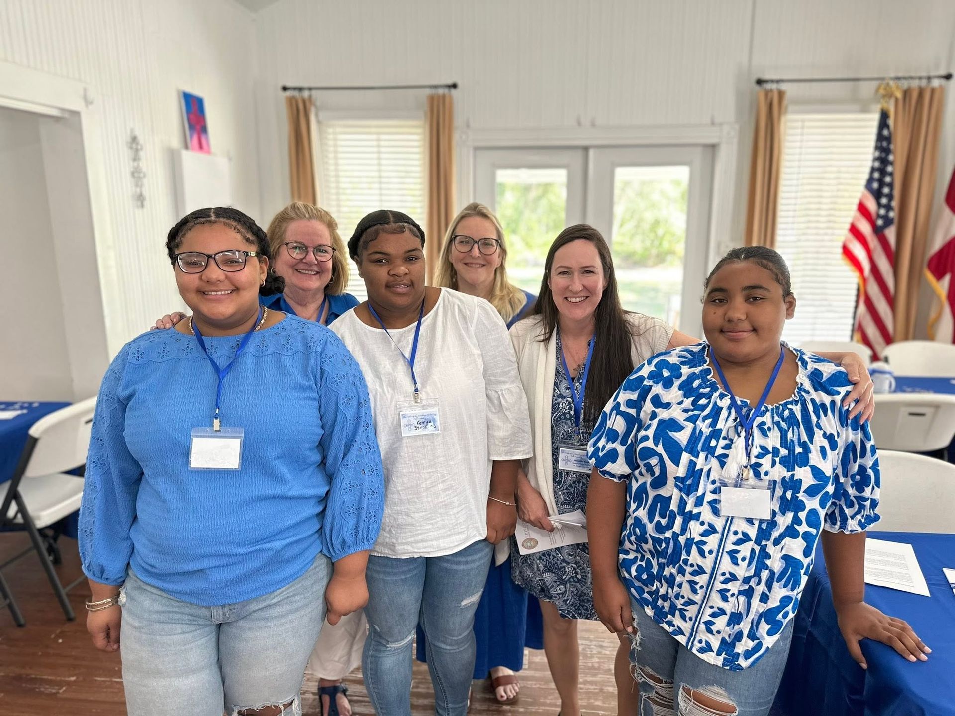 A group of DOK women wearing blue and badges.