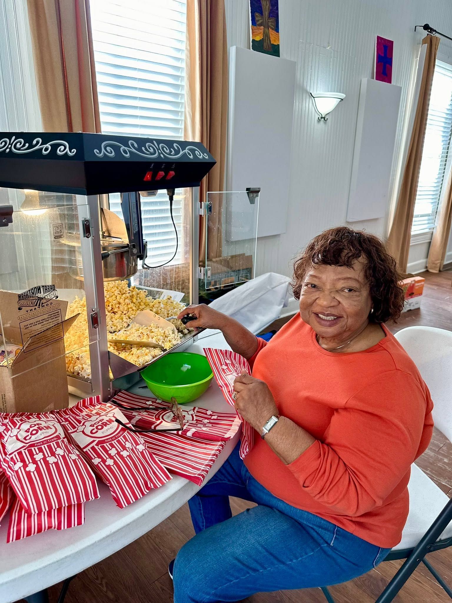 A church member serving from a popcorn machine.