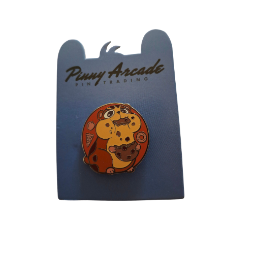 Pin of a brown hamster eating a cookie on a blue Pinny Arcade card.