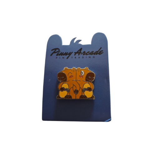 Pinny Arcade pin: Brown, cartoon-style hippos hugging on a blue card with logo.