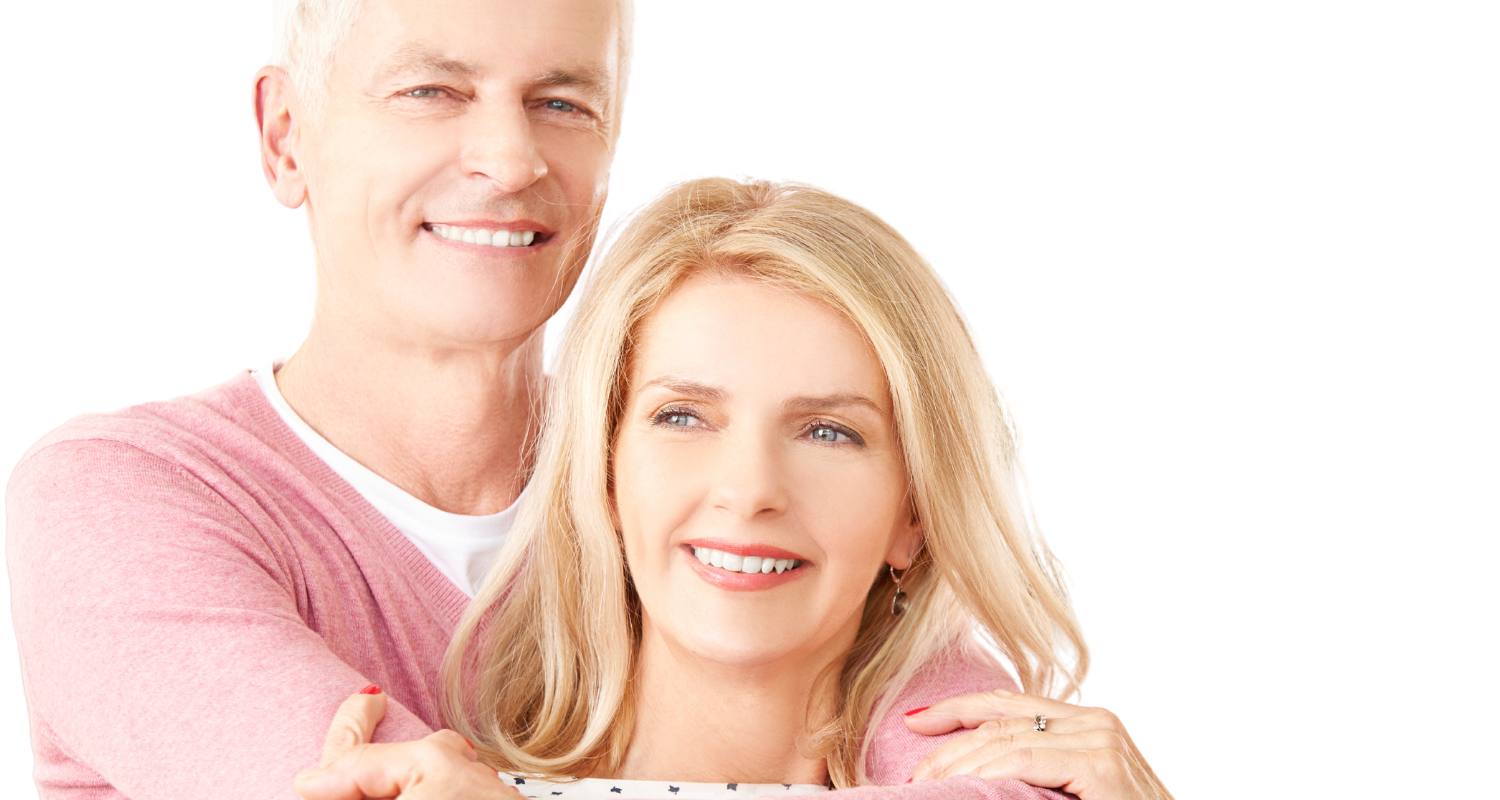 Two people smiling and embracing against a plain white background.