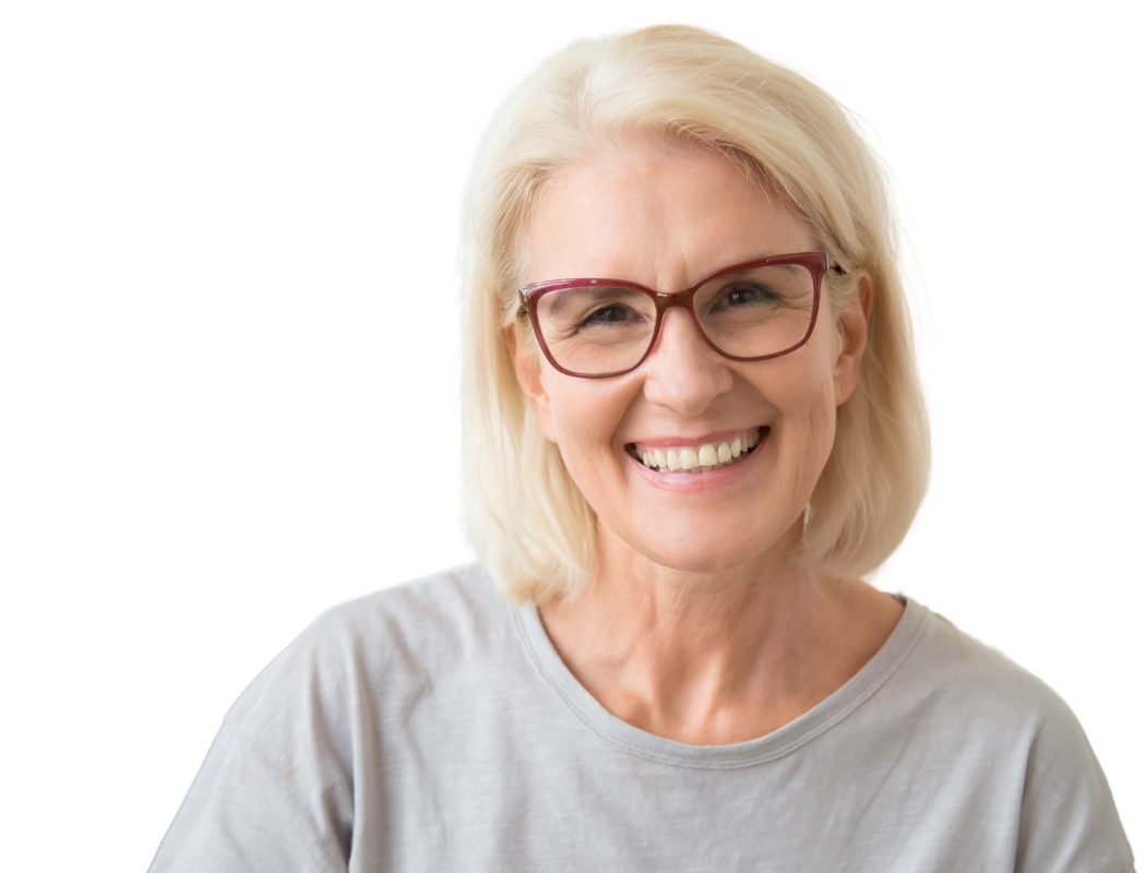 Smiling person with blonde hair wearing red-rimmed glasses and a grey t-shirt against a white background.