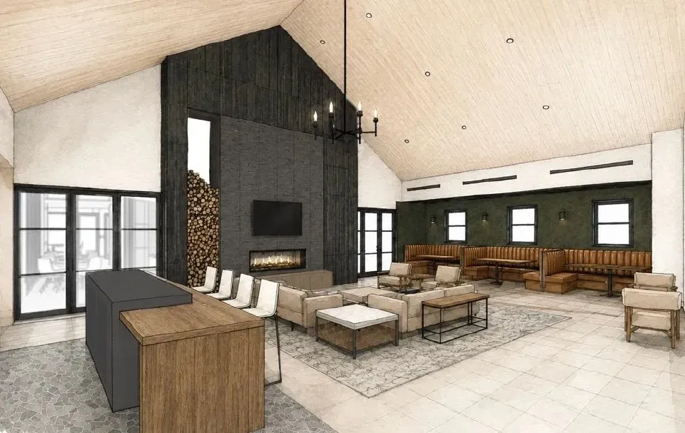 Interior of a modern lounge area with a fireplace, bar, and seating.