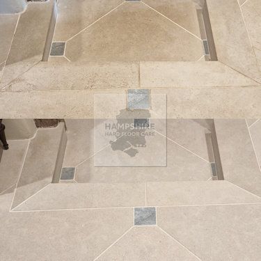 Tumbled limestone floor cleaned and enhanced to reveal natural colour
