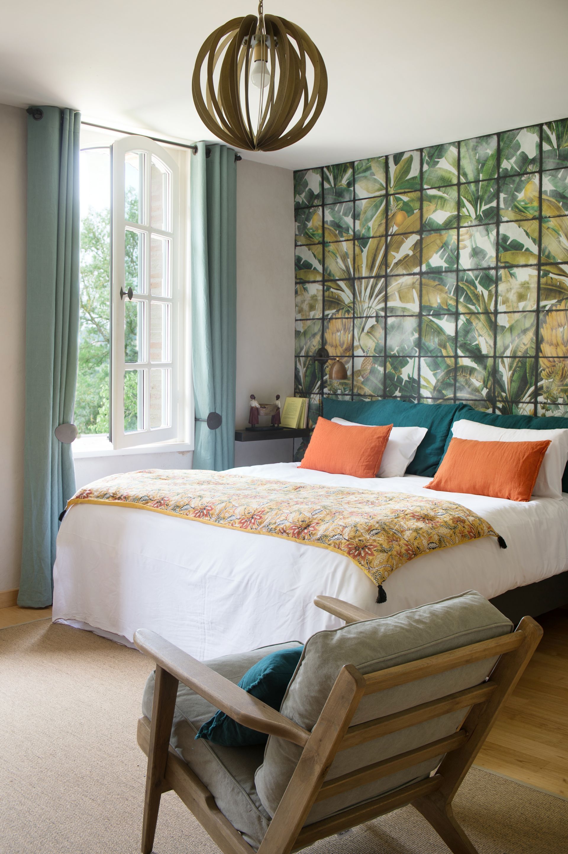A bedroom with a bed , chair , and window.