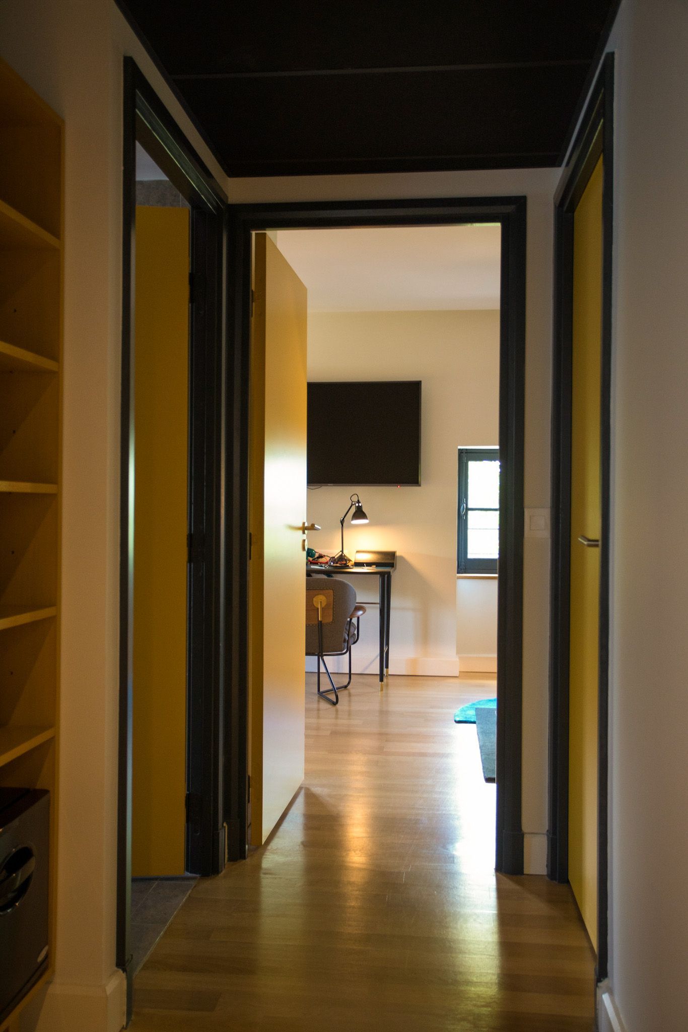 A bedroom with a large bed and a painting on the wall.