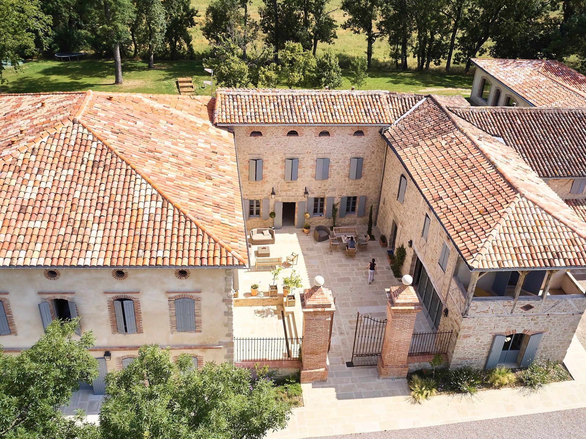 An aerial view of a large building with a red tiled roof