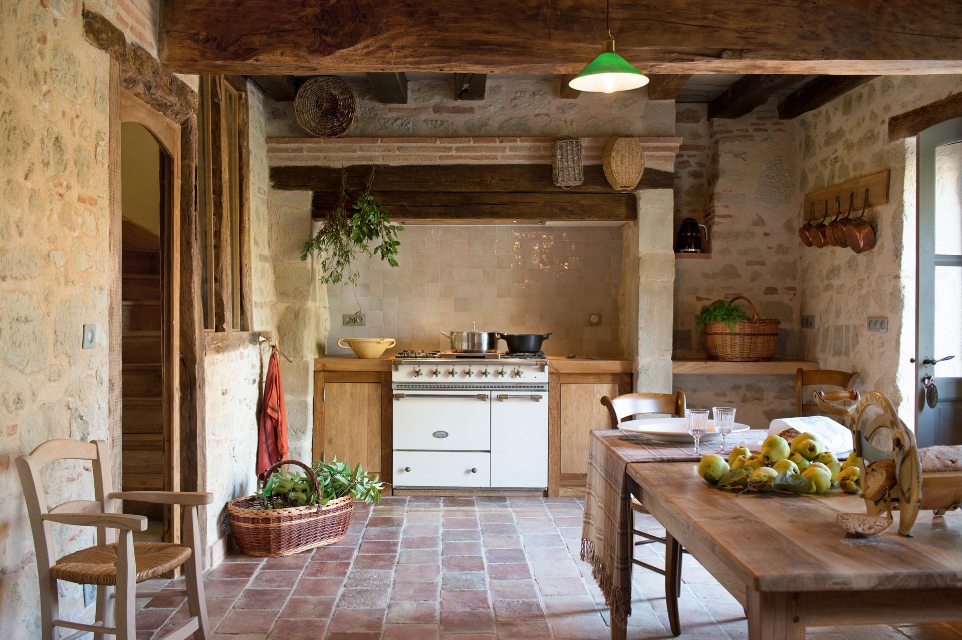 A kitchen with a table and chairs and a stove