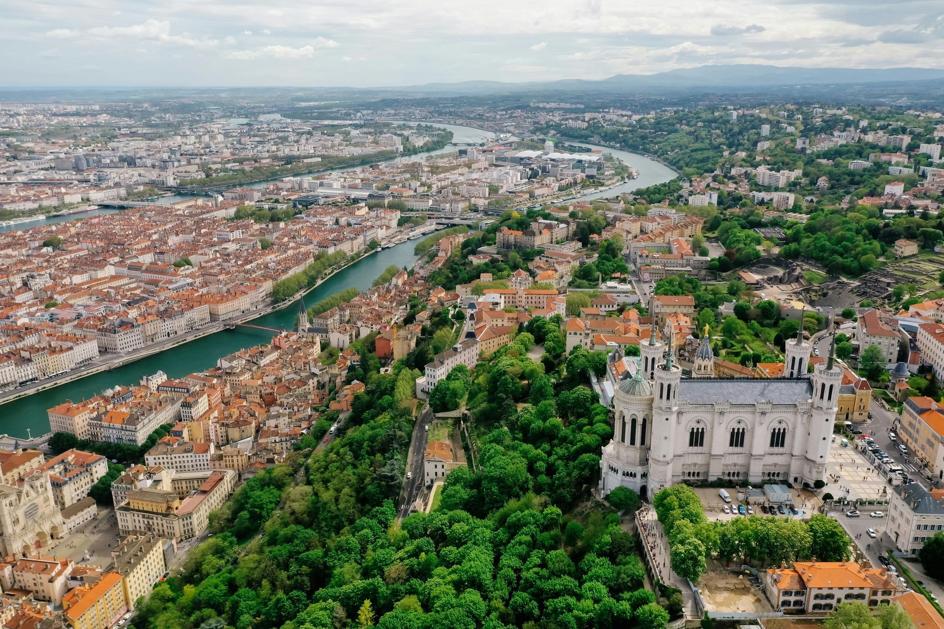 An aerial view of a city with a castle in the middle of it.