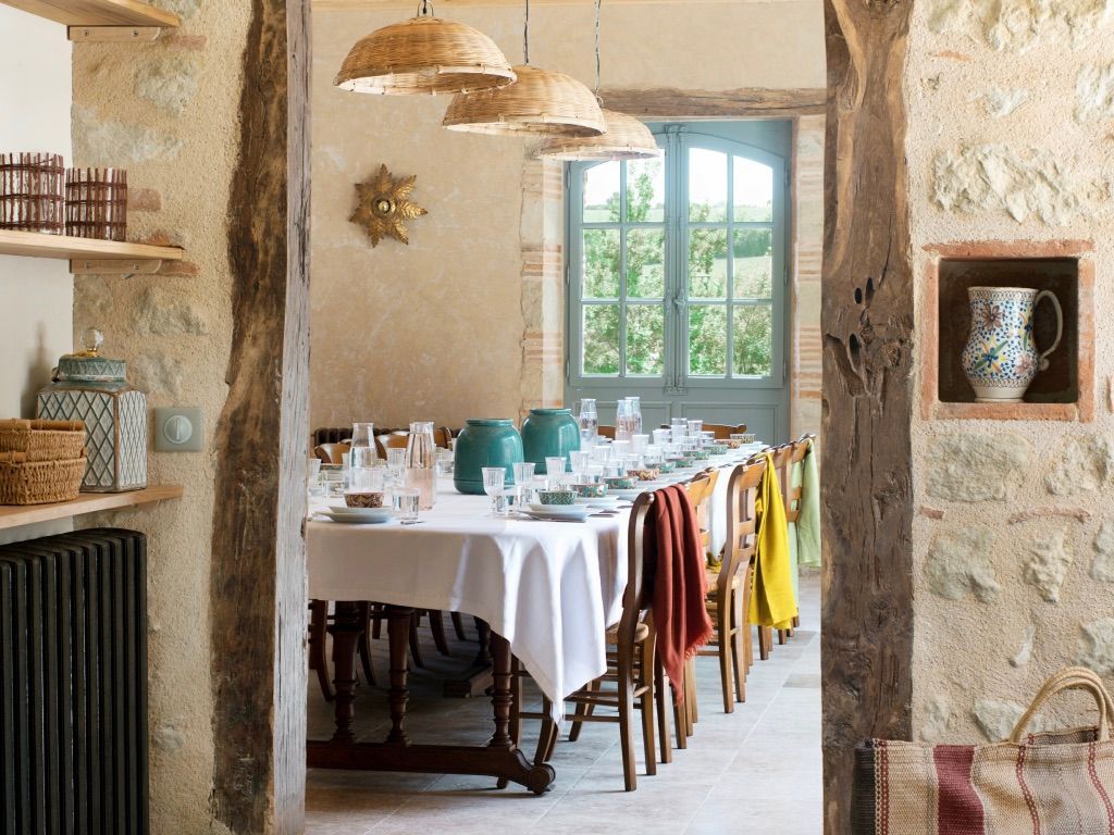 A dining room with a long table and chairs.