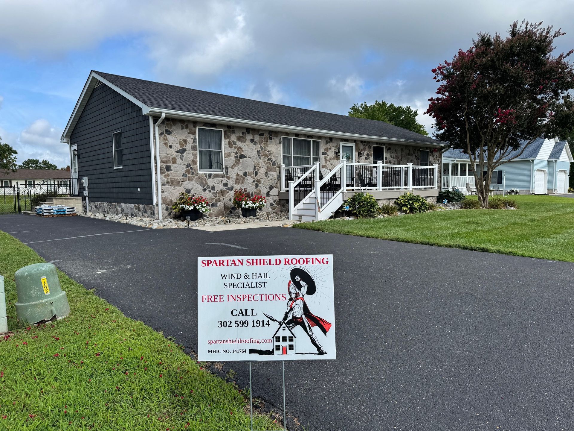 Modular office building with a front porch and lawn, plus a sign for septic and sewer services.