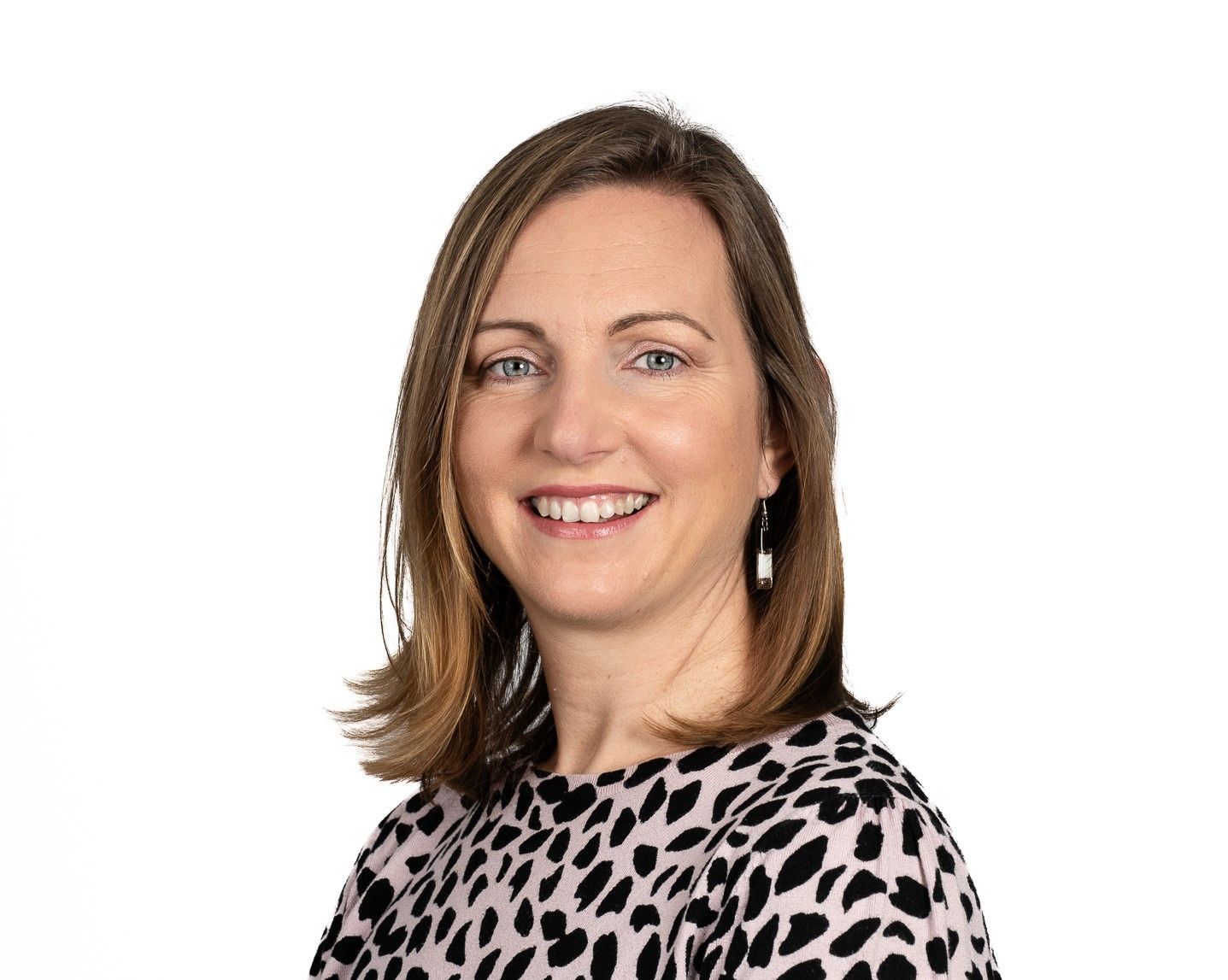 Meet the workplace investigators - Emily is wearing a leopard print shirt is smiling for the camera .