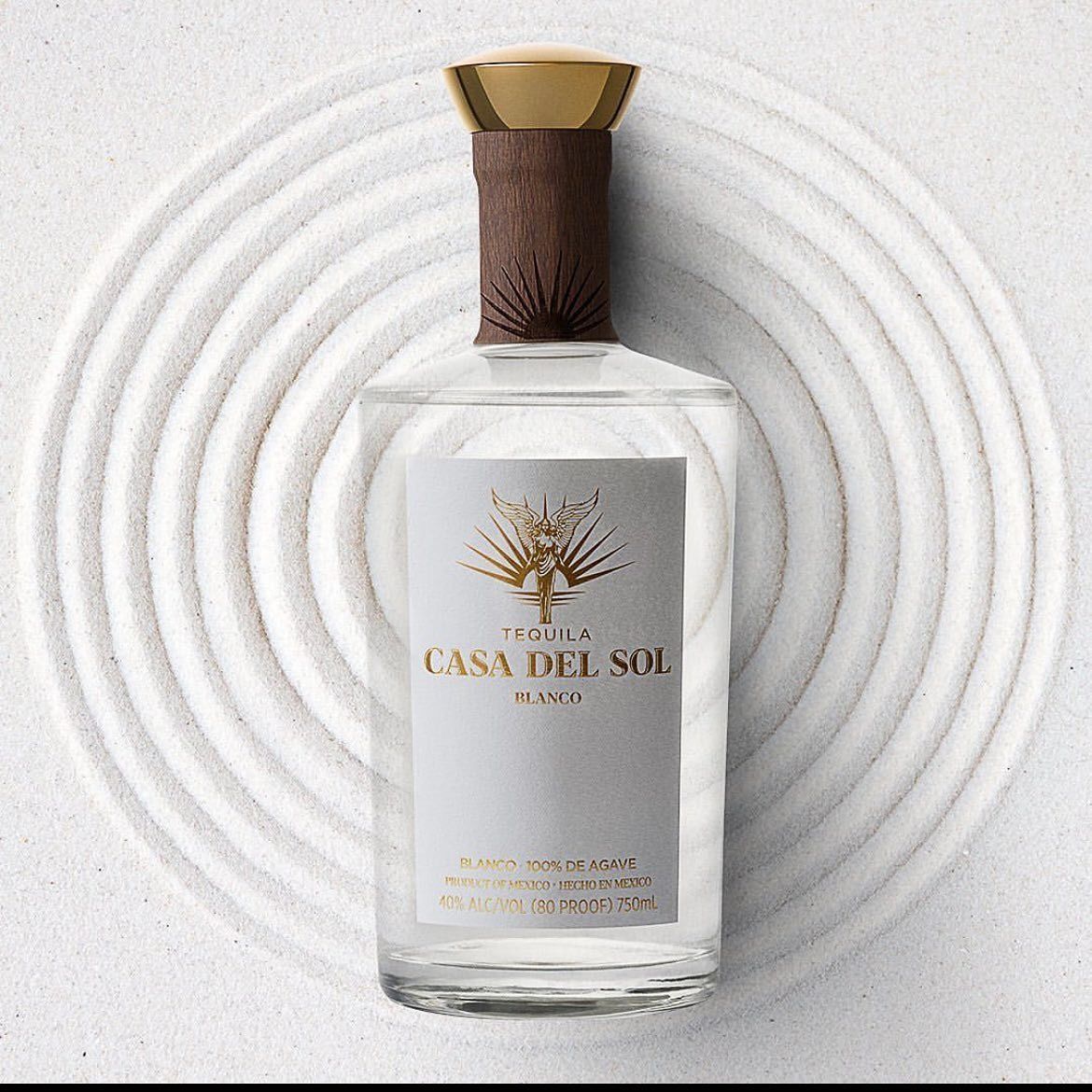 Casa Del Sol tequila bottle on a white background with concentric circle patterns.