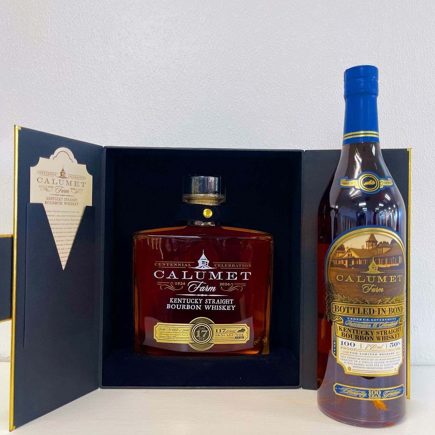 Calumet Farms bourbon in a box, blue and gold label, bottle next to an open box.