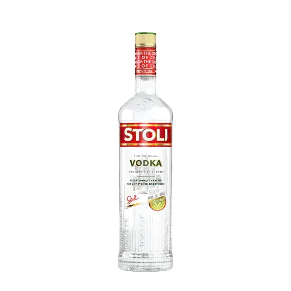 Bottle of Stoli vodka with a red and gold label and green accents.