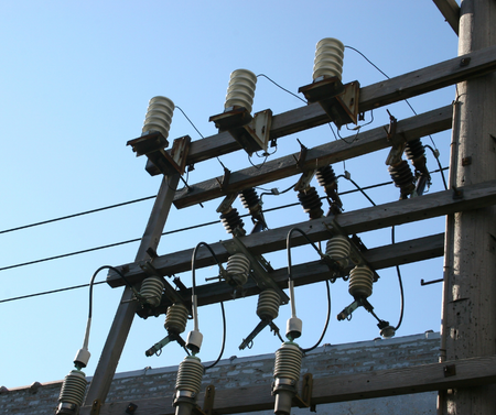 A bunch of electrical wires hanging from a pole
