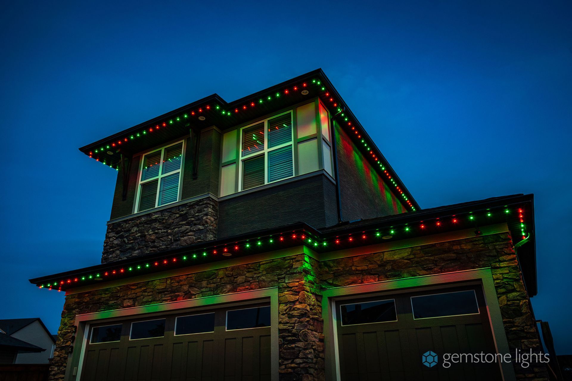 Red and Green Holiday Gemstone Lights Pattern on a two story home