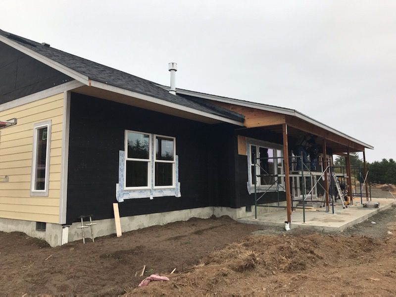 A house that is being built with a lot of windows
