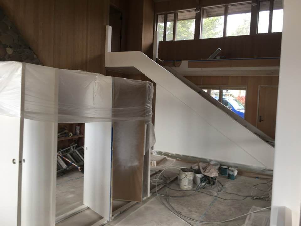 A room with a staircase in the middle of it