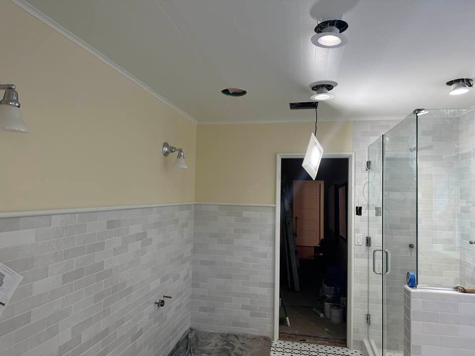 A bathroom with a walk in shower and a sink.