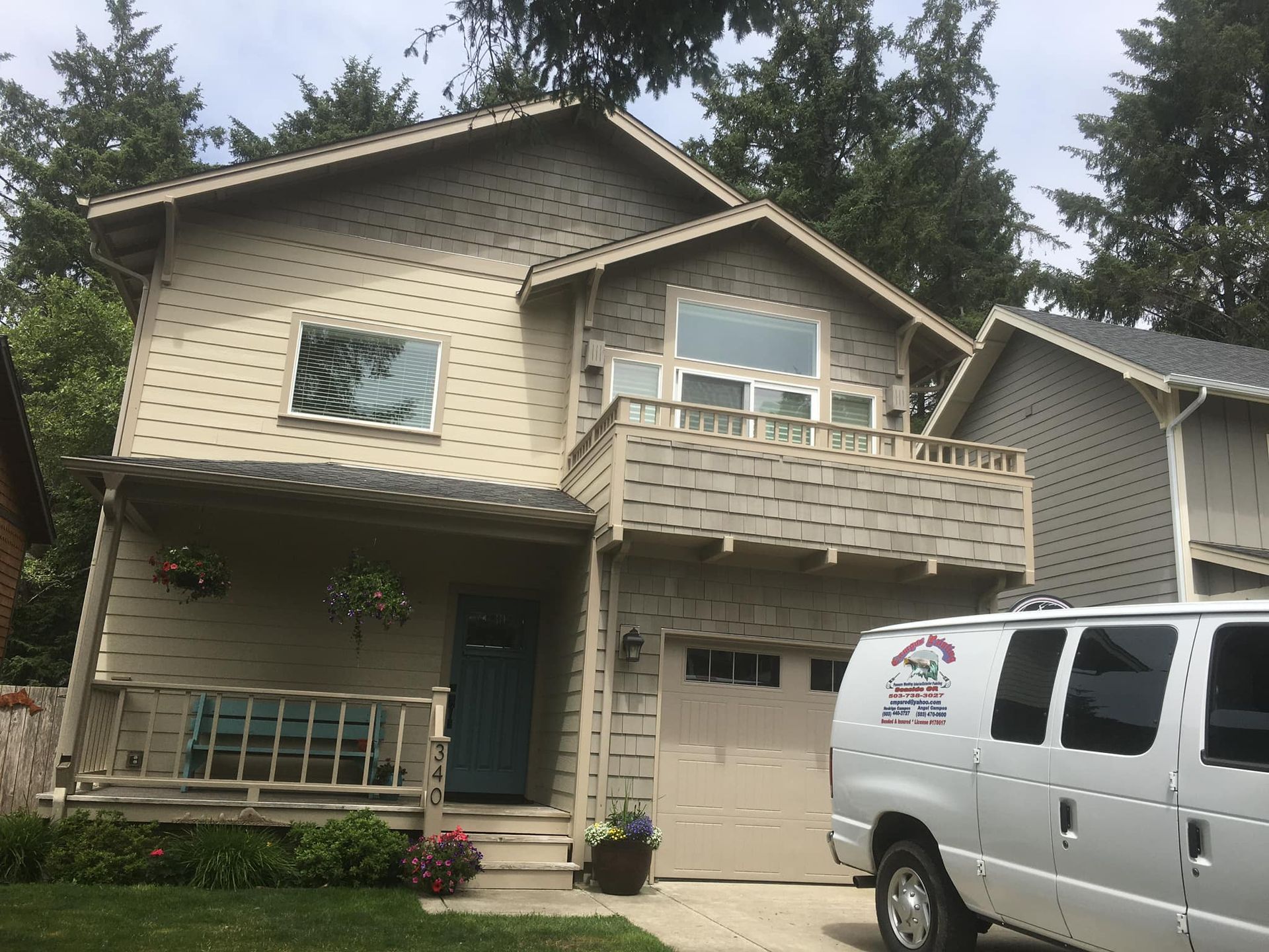 A white van is parked in front of a house.