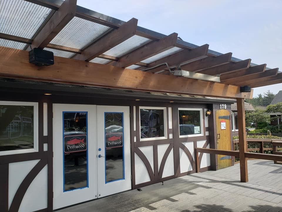 A building with a pergola over it and a lot of windows