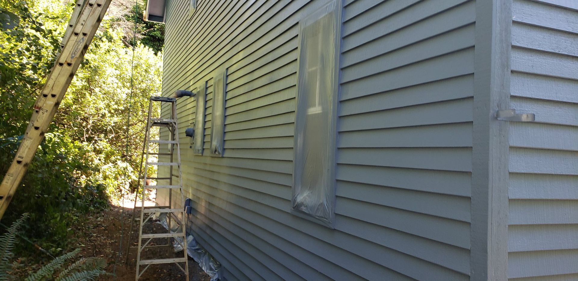 A ladder is sitting on the side of a house.