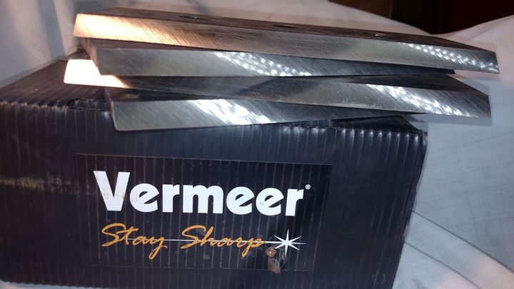 Vermeer Stor-Short logo on a black box with stacked reflective metal pieces on top