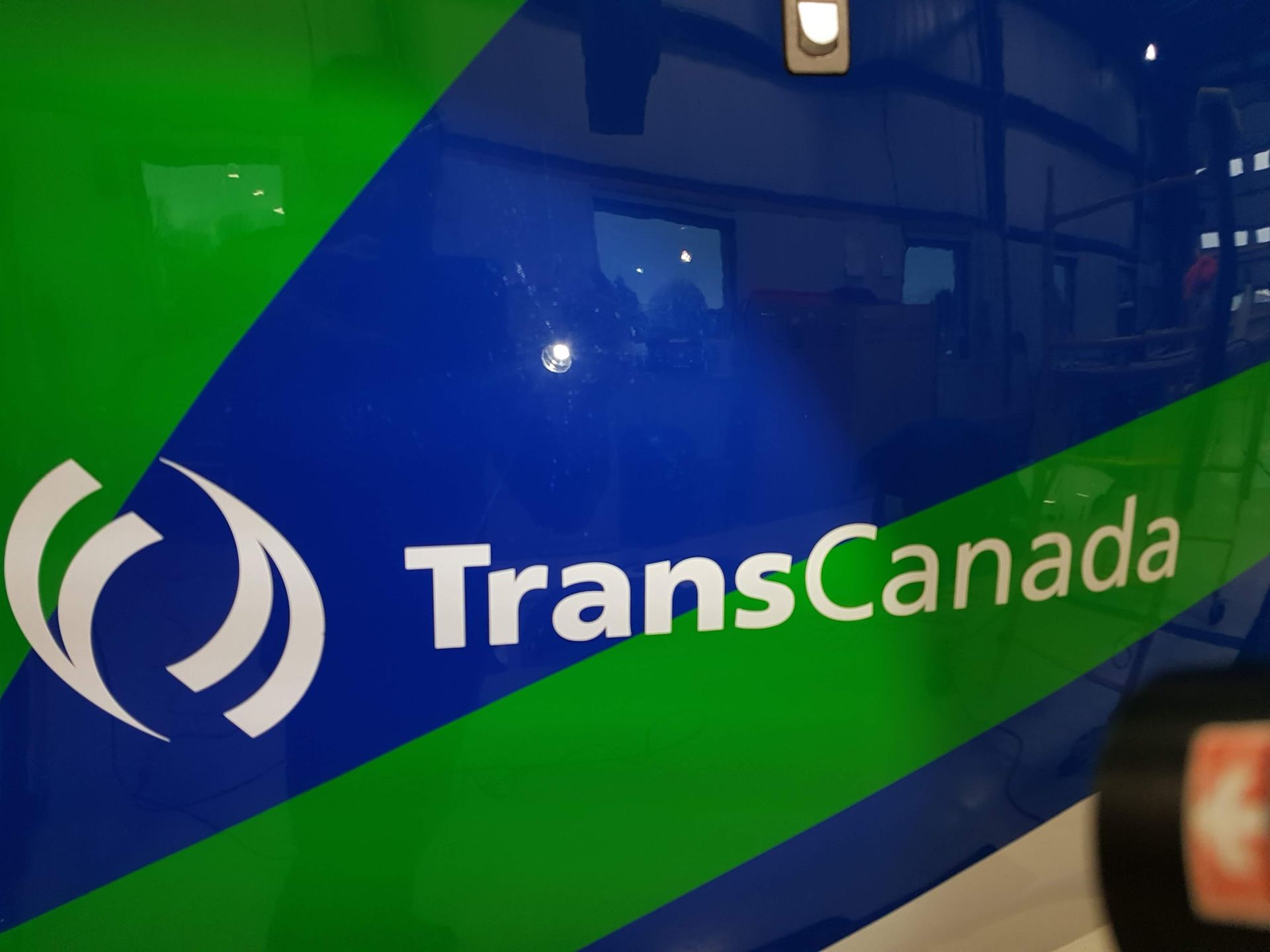 TransCanada logo on a blue and green vehicle.