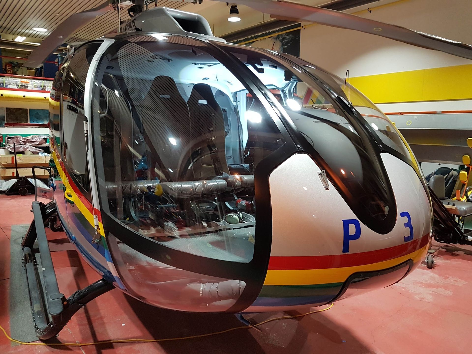 Helicopter cockpit with black frame and reflective windshield, displaying the number