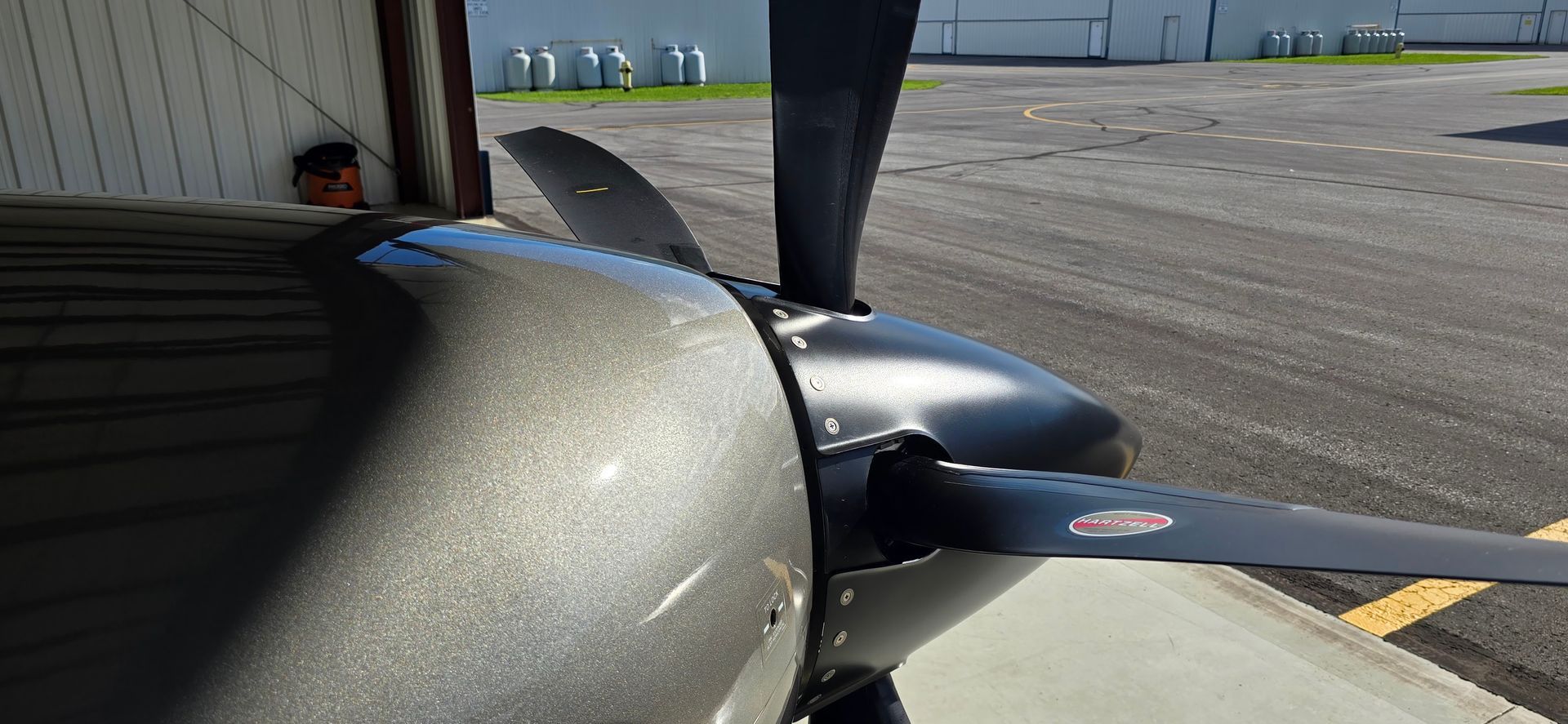 Close-up of an airplane propeller with a dark gray metallic finish.