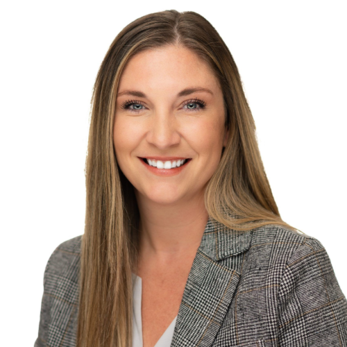 Smiling professional in a gray blazer against a white background