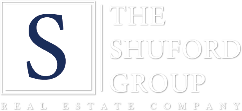 Logo for The Shuford Group Real Estate Company with a large blue “S” and white text