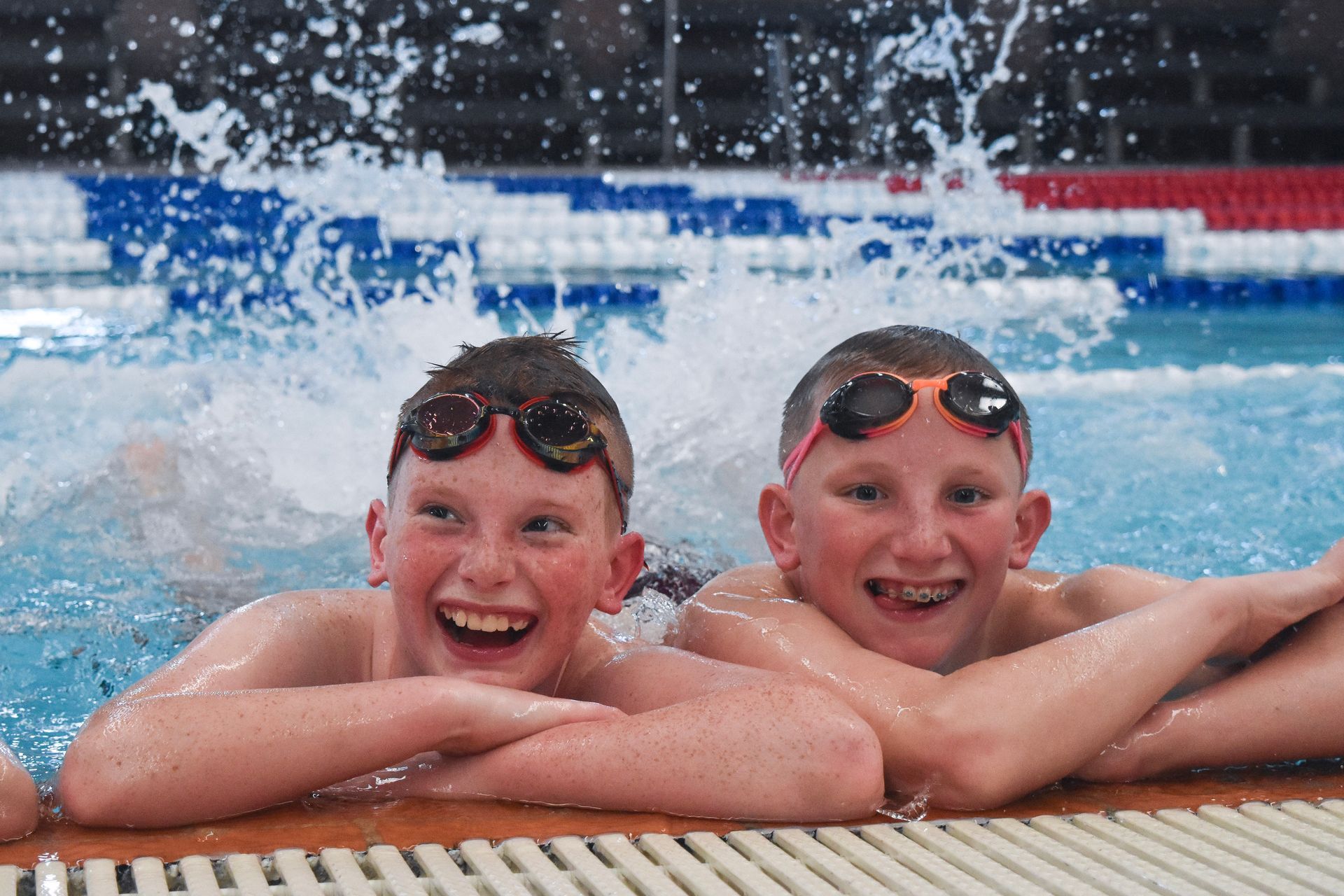 two boys in pool splashing