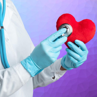 A healthcare professional in a white coat and blue gloves uses a stethoscope to examine a plush red heart.