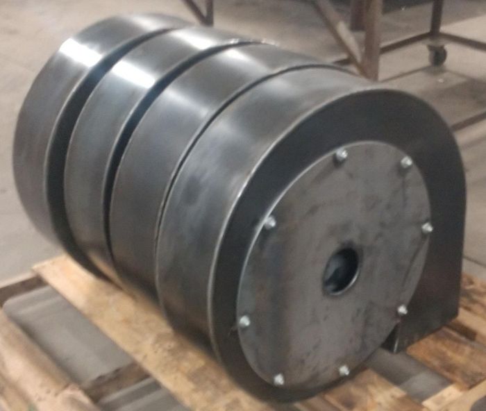 A large metal object is sitting on a wooden pallet