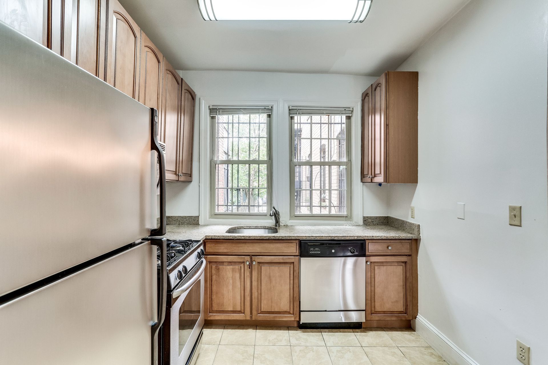 A kitchen with stainless steel appliances and wooden cabinets