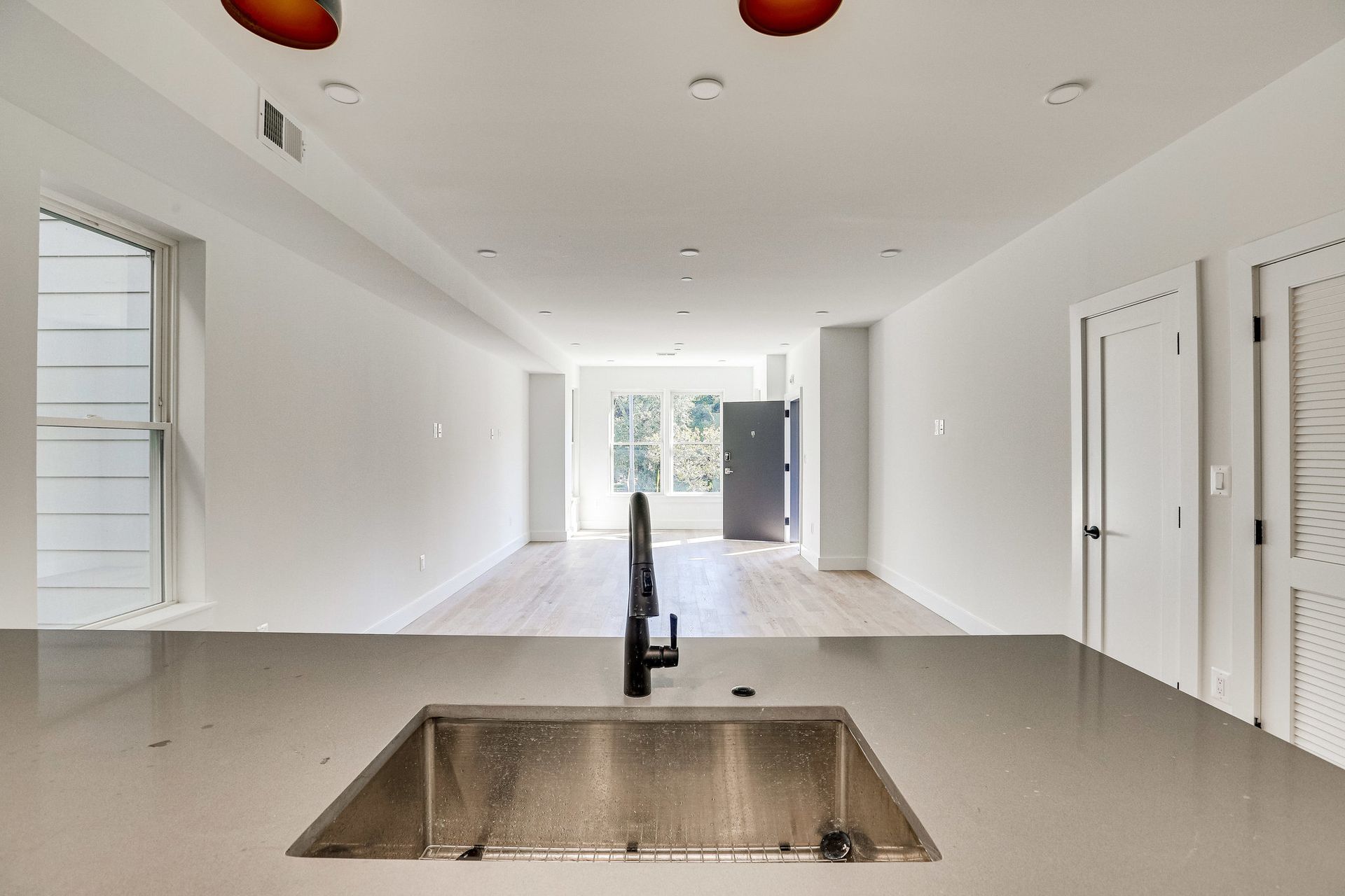 An empty kitchen with a sink and a faucet