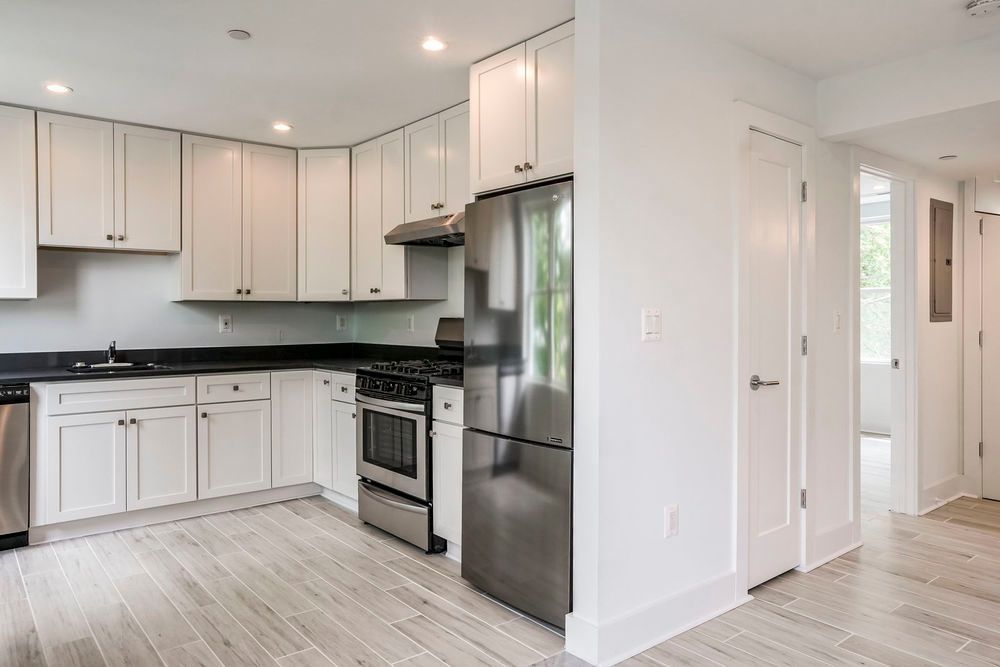 A kitchen with white cabinets and stainless steel appliances.