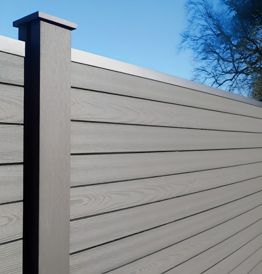 Light gray horizontal slat fence with a dark post against a blue sky