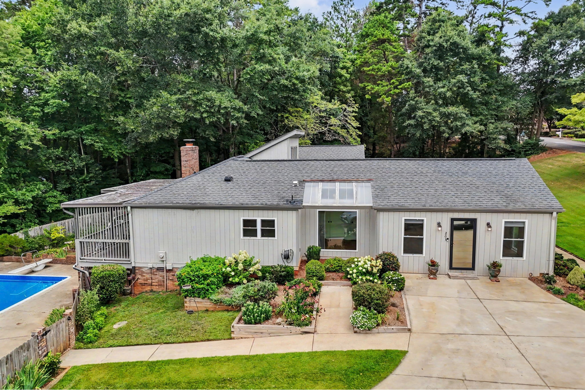 Residential home with landscaped yard and pool in Seneca, South Carolina
