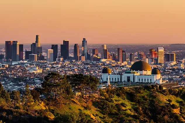 Los Angeles skyline at sunset with Griffith Observatory in the foreground