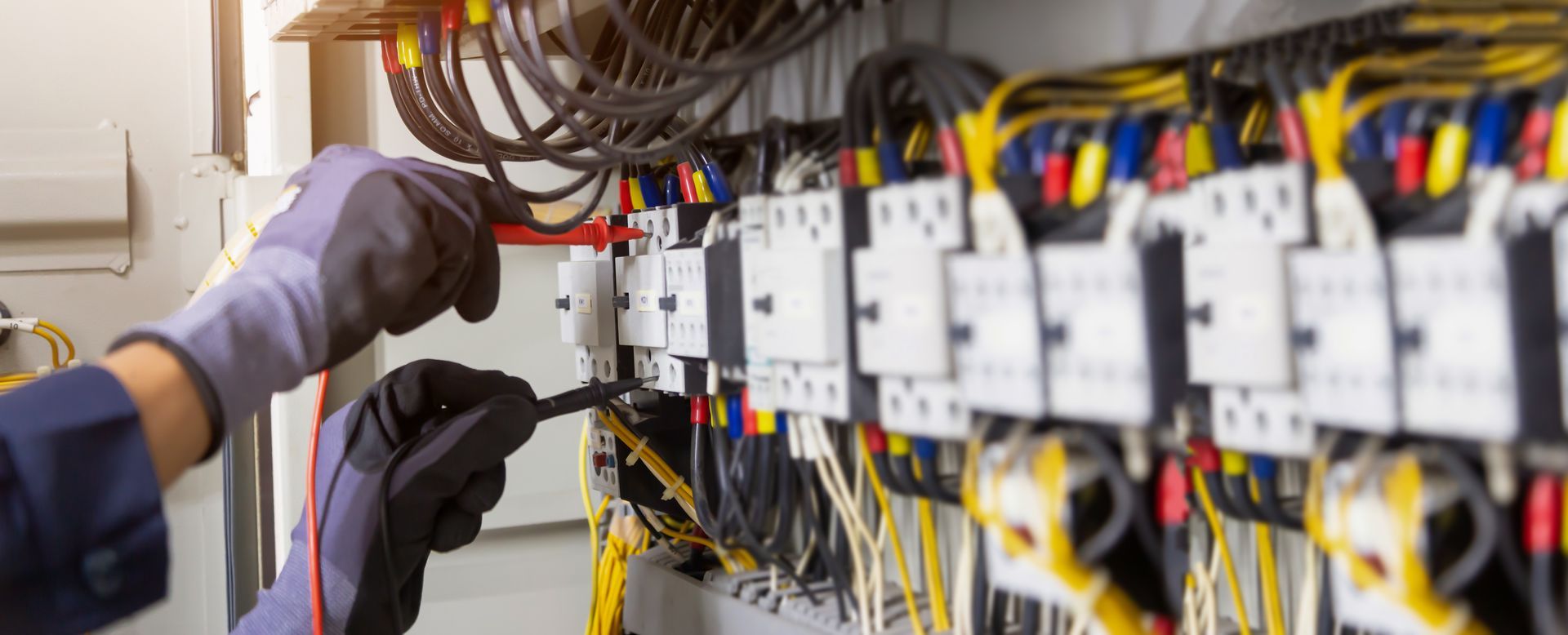 Electrician tests electrical installations and wires on relay protection system. Electrician tests electrical installations and wires on relay protection system.