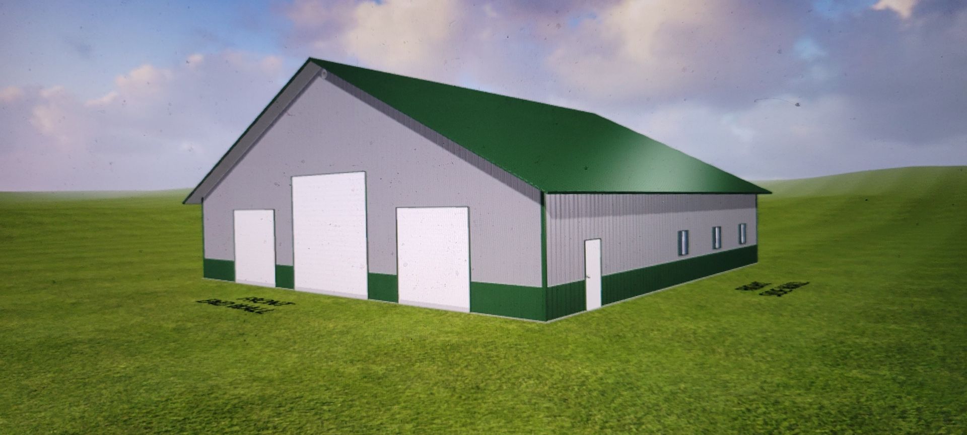 Gray and green metal barn on a grassy hill under a cloudy sky.