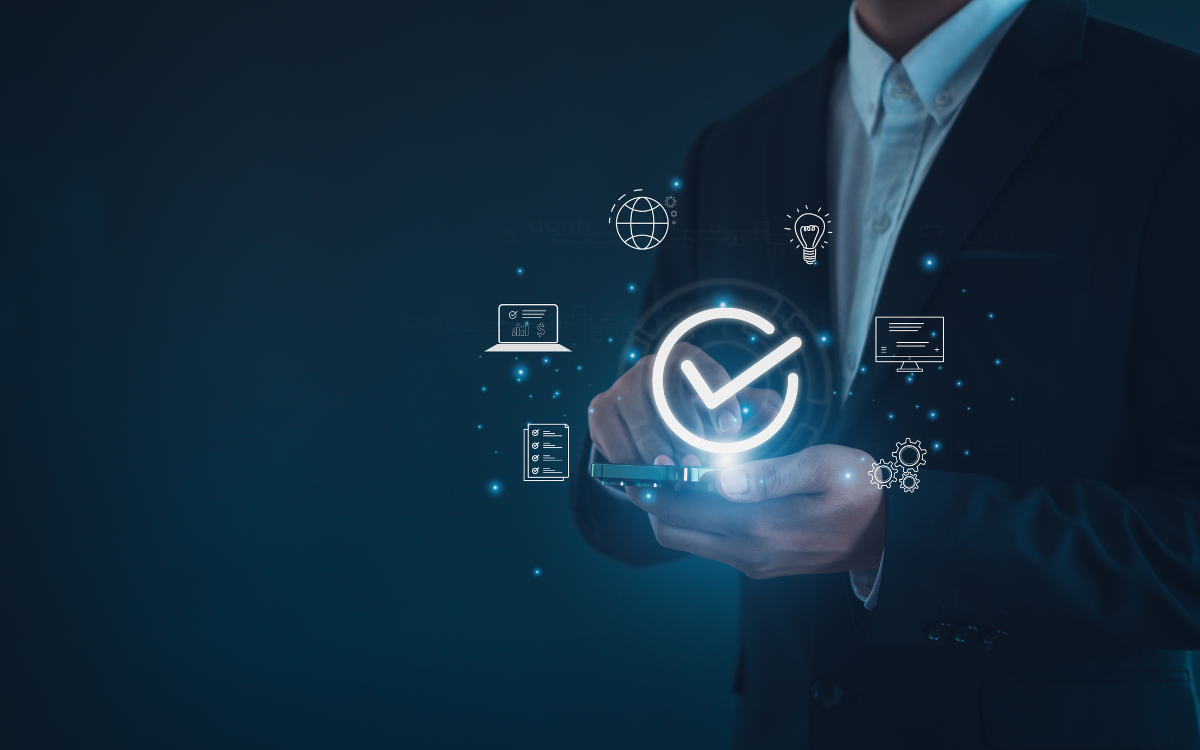 Businessman in suit holding a phone, with glowing checkmark and icons representing quality assurance. Dark blue background.