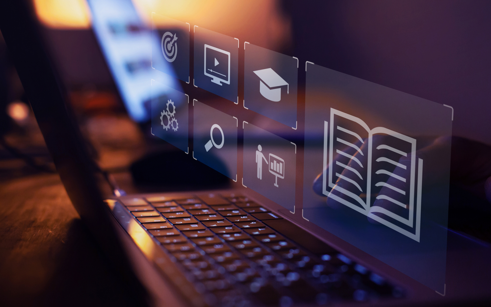 Laptop with educational icons overlaid, representing online learning.