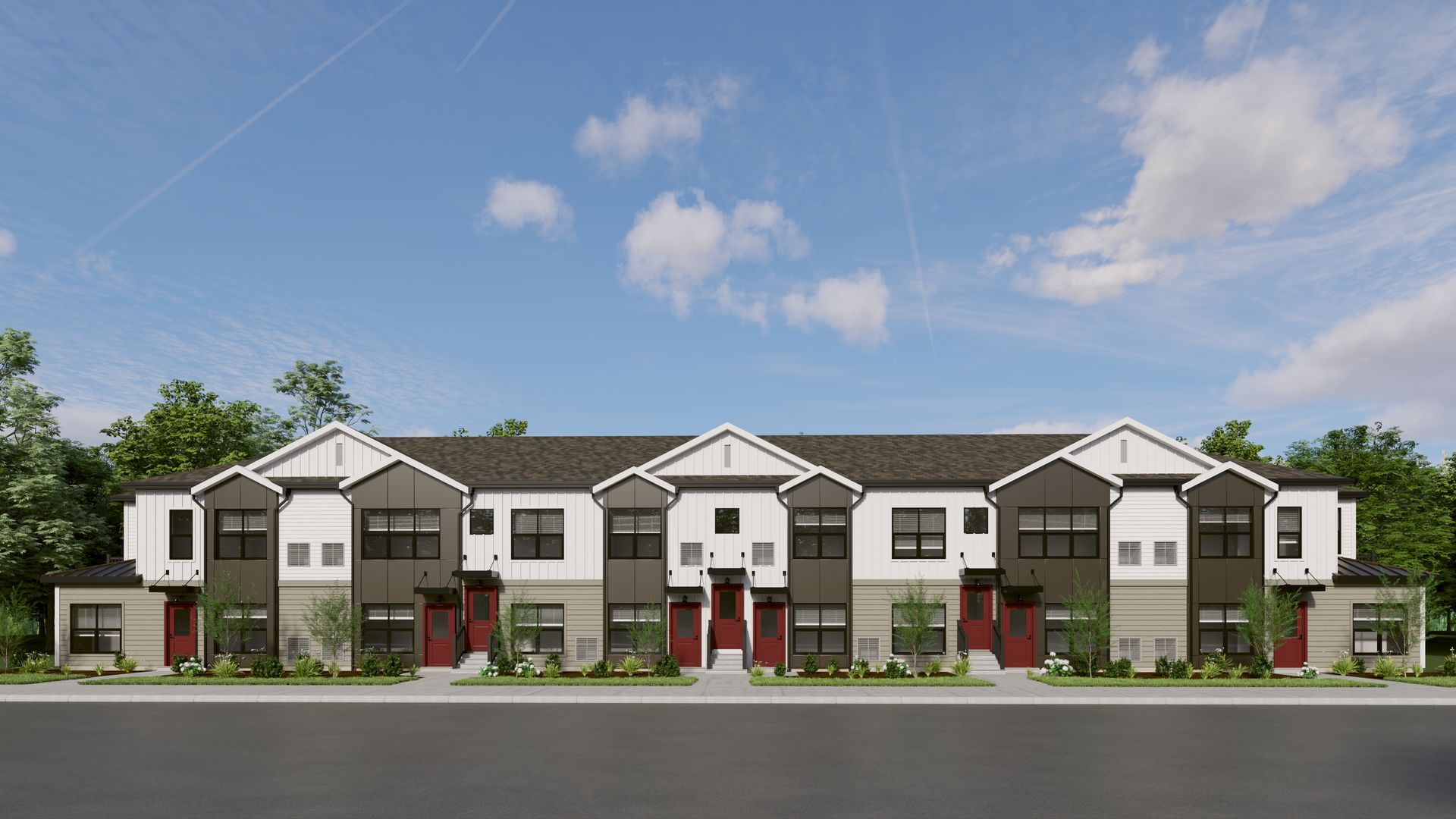 A modern, two-story townhome complex with white and dark gray siding, featuring multiple entrances and peaked roof gables.